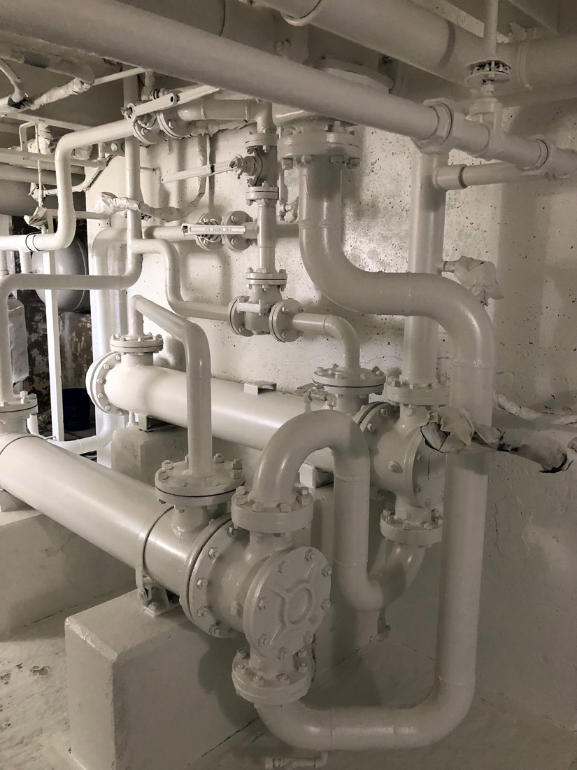 Industrial piping and valves finished in a durable protective coating